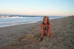 Sarah Carter building a fort at sunset at Kitty Hawk, NC.