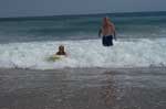 Doss Miller helping Sarah with her boogie board.