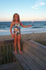 Sarah holding a sparkler on the beach at Kitty Hawk, NC.