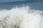 The top of Sarah's head is just showing above the breaking wave at Kitty Hawk, NC.