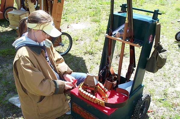 Sarah reloading Ray's shotgun belt.